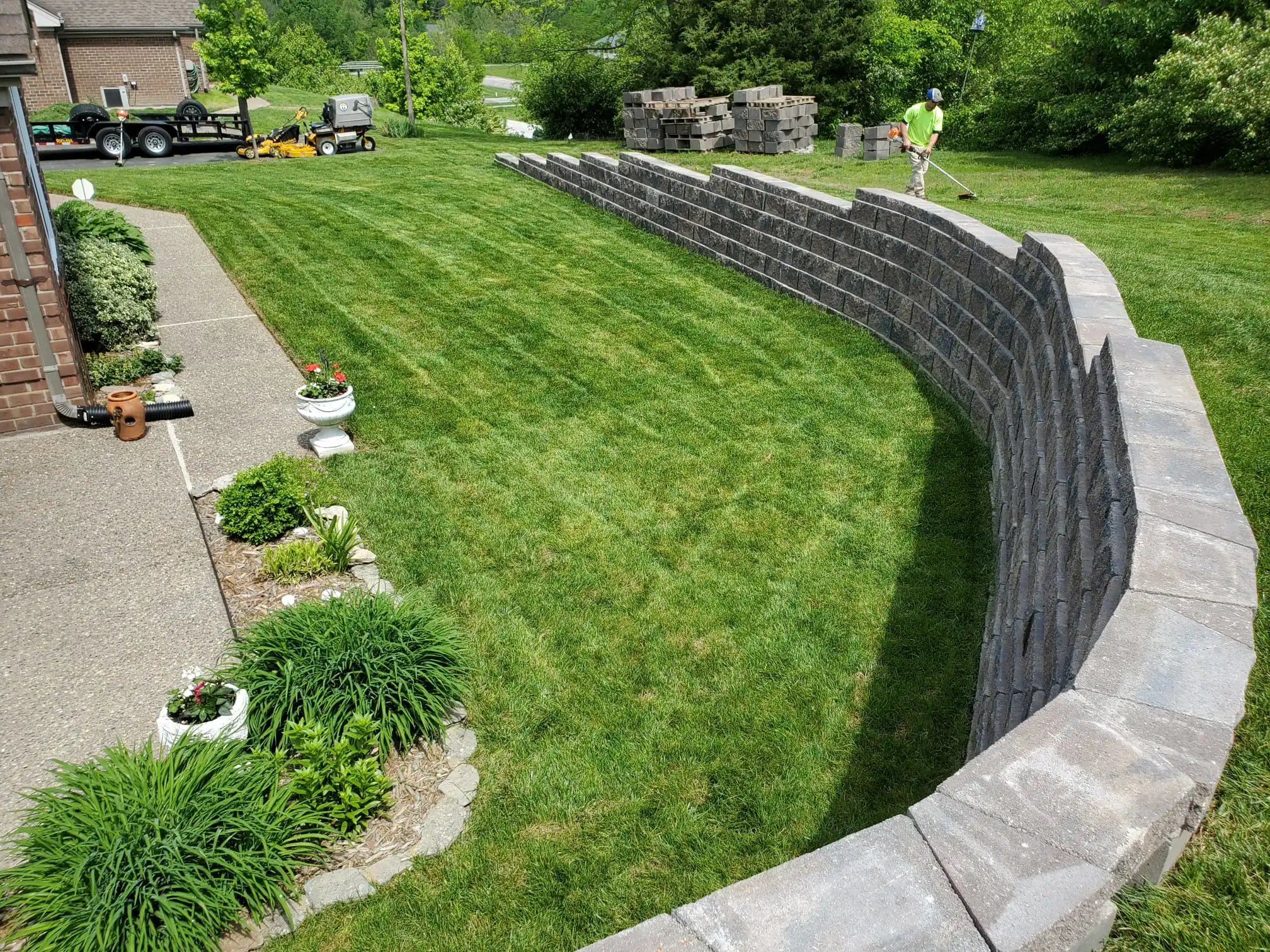 Stoneview-Gardens-large-retaining-wall-8-submerged-downspouts-30-tons-of-gravel-95-tons-of-processed-soil-5000-SF-of-new-sod-lawn
